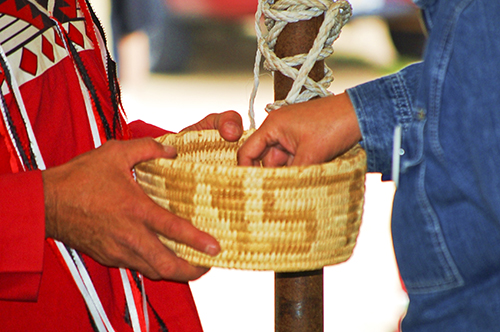 Don Holding Weaved Basket full of Tobacco